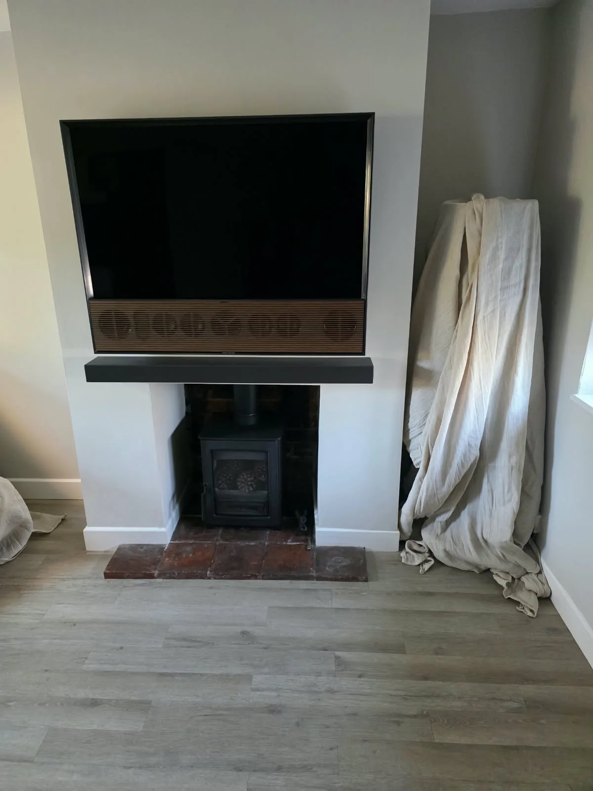 Bespoke matt black porcelain shelf installed above the customer's existing stove in Knowle
